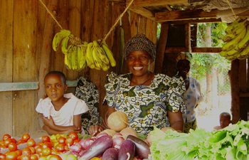 African woman and girl with bananas and fruit.