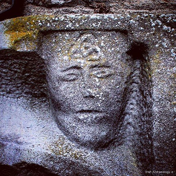 A Celtic trinity knot on the forehead of a person in the north transept of St. Mary's Church in New Ross, Ireland. The church is nearly 800 years old.