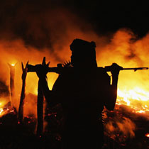 The Darfur village of Chero Kasi burns after government-supported Janajaweed militia set it ablaze.