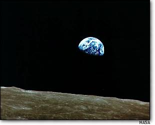 The earth rises above the lunar horizon in this Apollo 8 photo
