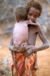 Somalia famine (girl carrying baby).